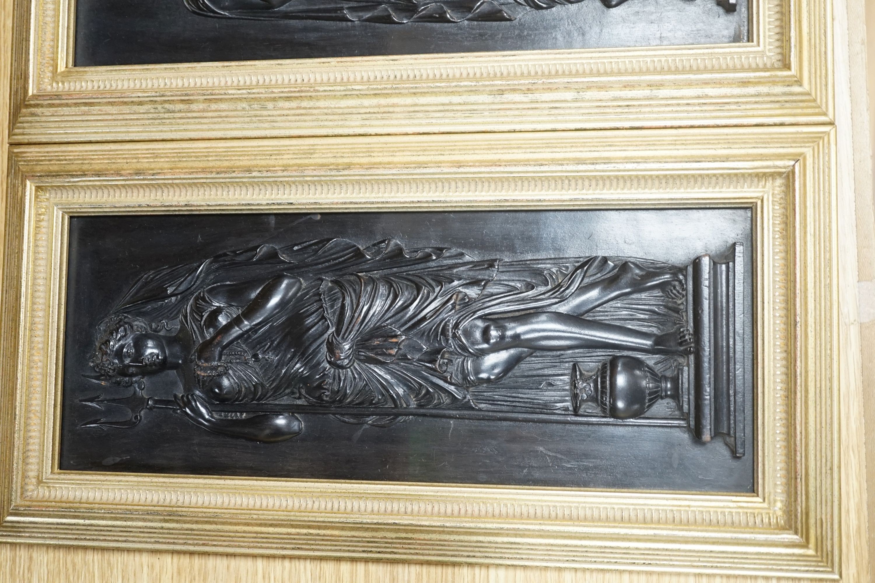 A pair of carved and ebonised wood panels of Grecian muses, by N. Laval. c.1830, framed